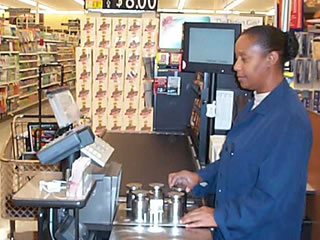 Picture of inspector checking a weighing device in a grocery store.