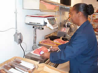 Picture of inspector checking pre-packaged meat.