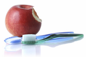 an apple and toothbrush