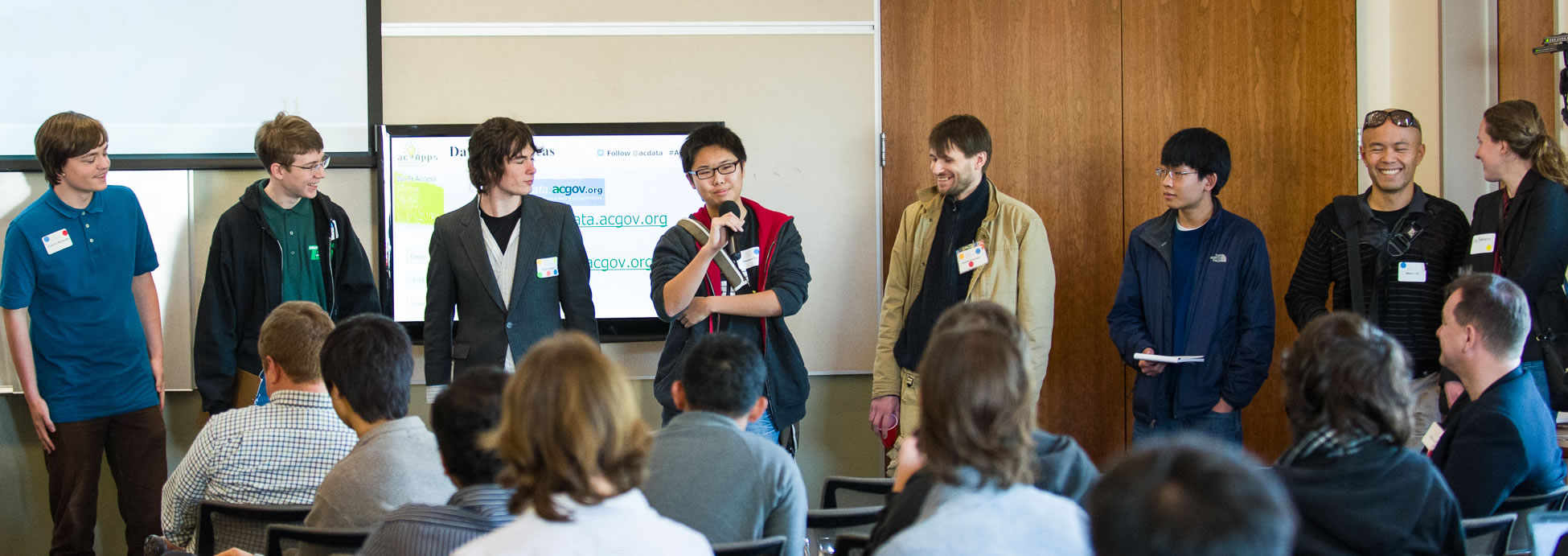 Photo of hackathon participants pitching their app ideas.