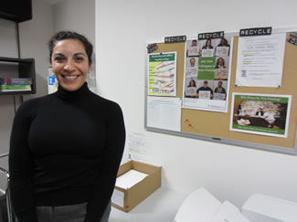 Photo of Green ambassador standing next to Recycle bulletin board.