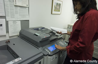 Photo of employee selecting 2 sided copies.