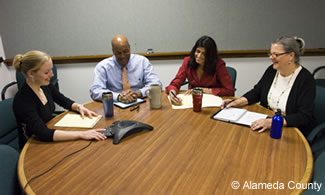 Photo of 4 County employees conducting a teleconference.